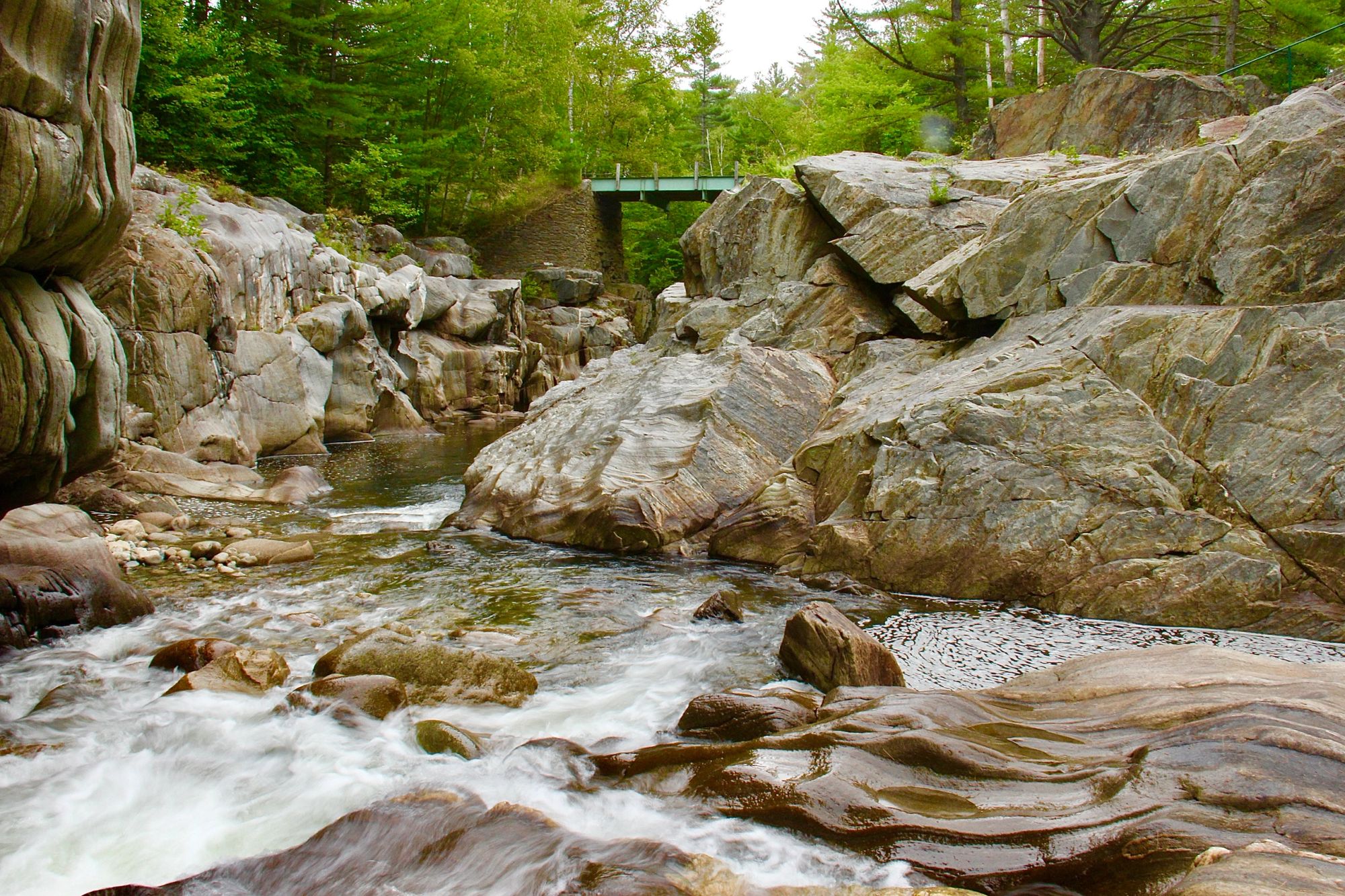 Water winding between smooth granite walls in the gorge