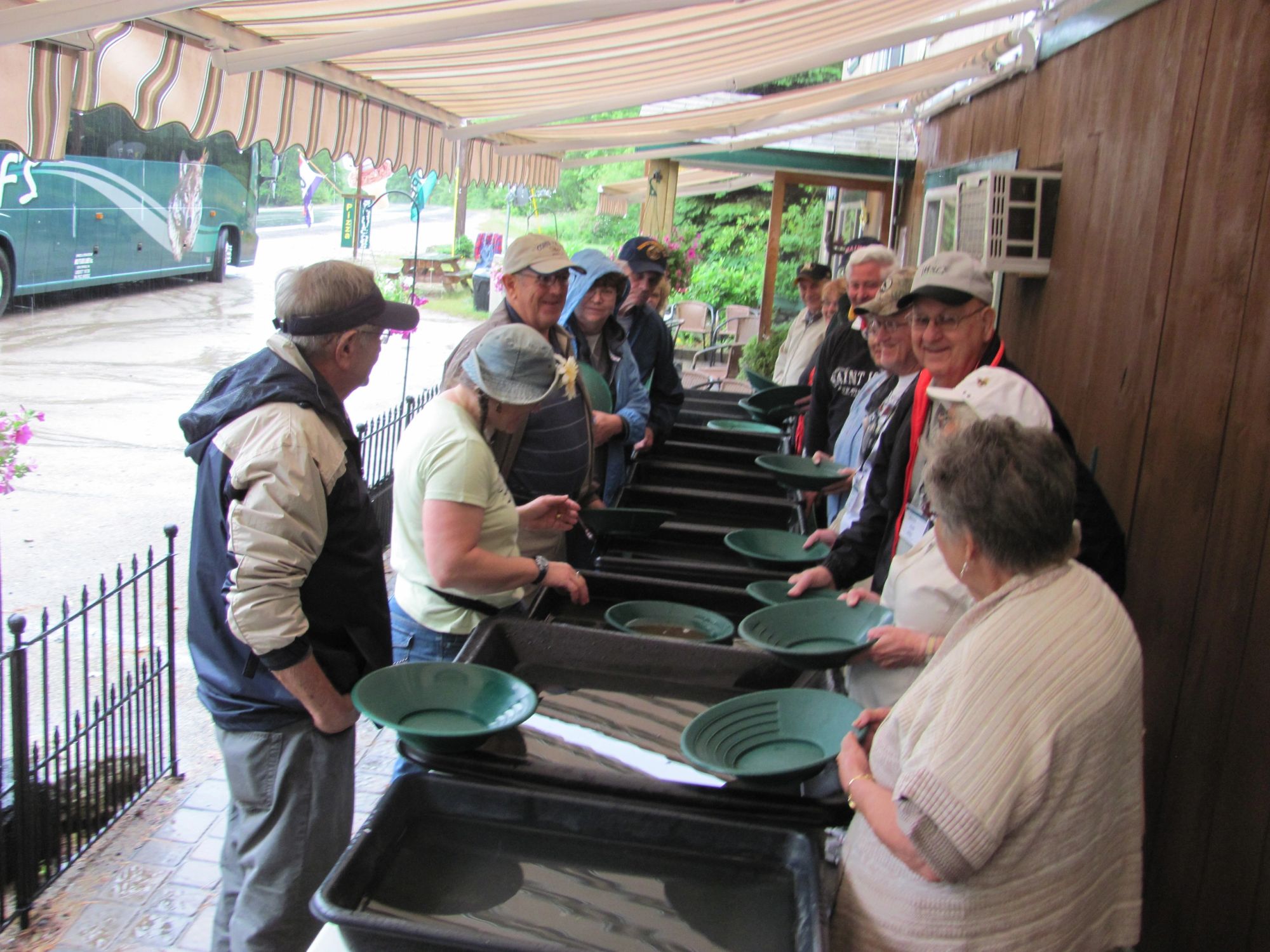 A row of people panning side by side at the shop’s covered flumes